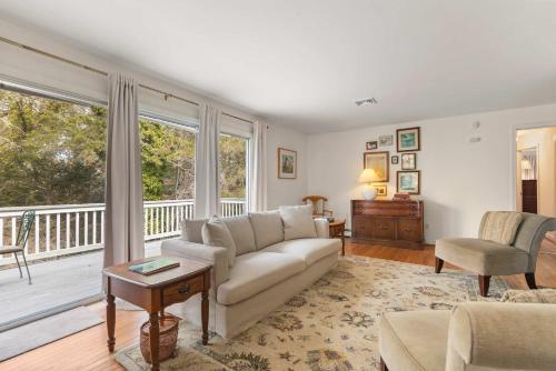 a living room with a couch and a balcony at Central AC Game Room Dog-Friendly in Chatham
