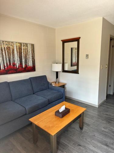 a living room with a blue couch and a table at Saddle Mountain Lodge in Blue River