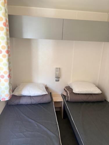 a room with two beds in a room at Camping la sainte baume in Nans-les-Pins