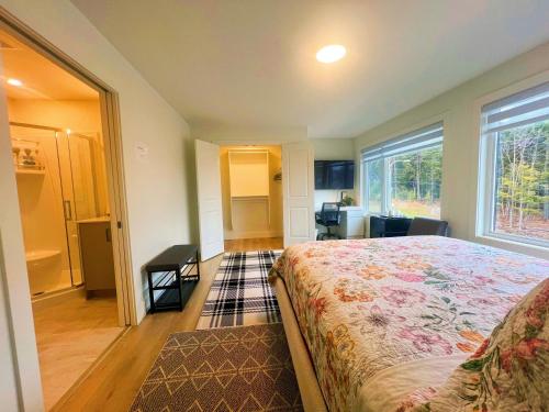 a bedroom with a bed and a large window at Morning Dew105 in Hammonds Plains