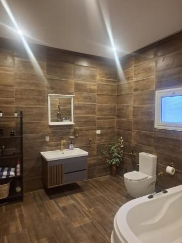 a bathroom with a tub and a toilet and a sink at Villa Casablanca in 6th Of October