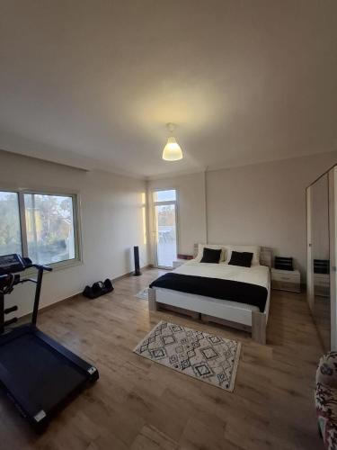 a bedroom with a bed and a treadmill in it at Villa Casablanca in 6th Of October