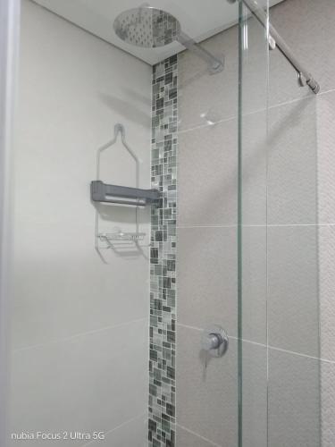 a bathroom with a shower with a glass door at Room cerca al aeropuerto #2 in Bogotá