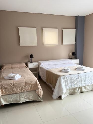 two beds sitting next to each other in a bedroom at Casa Olivia in Luján