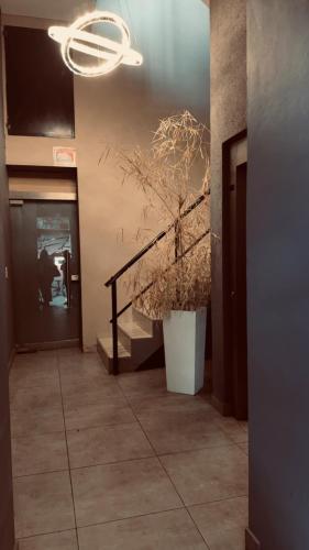 a hallway with a staircase and a plant at Casa Olivia in Luján