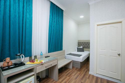 a bathroom with a sink and a toilet in a room at Empire Hotel Baku F1 view in Baku