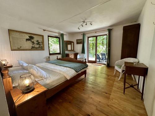 a bedroom with a large bed and a table at Boogie House in Rendeux
