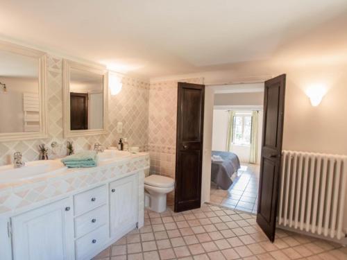 a bathroom with a sink and a toilet at Le Mas dormant in Fayence