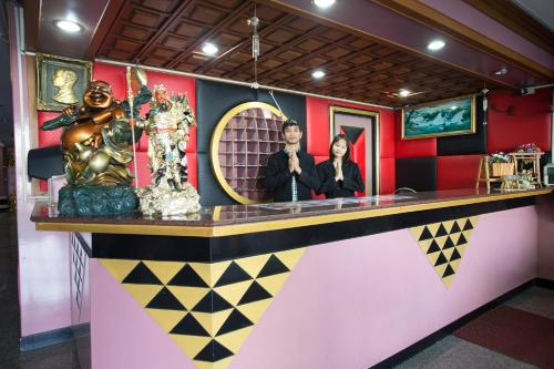 a dressing room with a mirror and a woman at Grand Leo Hotel in Khon Kaen