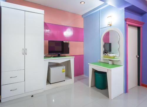 a colorful bathroom with a sink and a mirror at Grand Leo Hotel in Khon Kaen