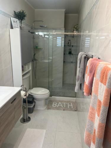 a bathroom with a shower and a toilet and a sink at B's Hidden Paradise in Philipsburg