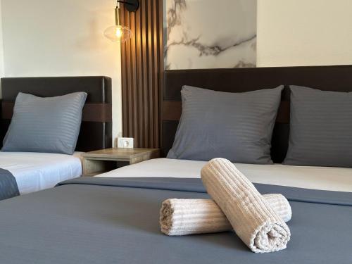 a bedroom with two beds with a footstool on the bed at STANDART Premium in Ulcinj