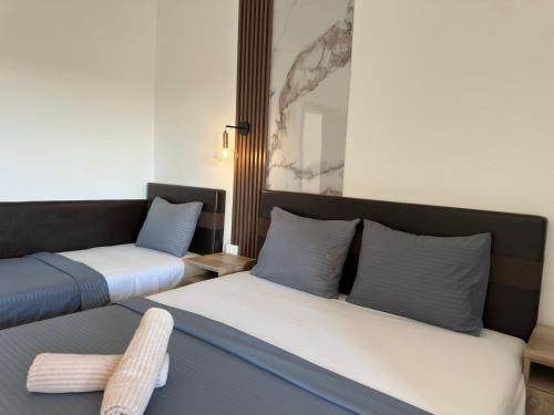 a room with two beds and a couch at STANDART Premium in Ulcinj