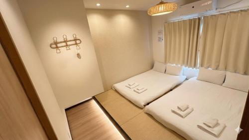 a small room with two beds and a window at Ueno 3m to Train 161m2 Villa 6BR 3Bath 4Toilet Skytree View in Tokyo