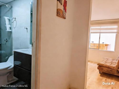 a bathroom with a shower and a toilet and a sink at Room cerca al aeropuerto #4 in Bogotá