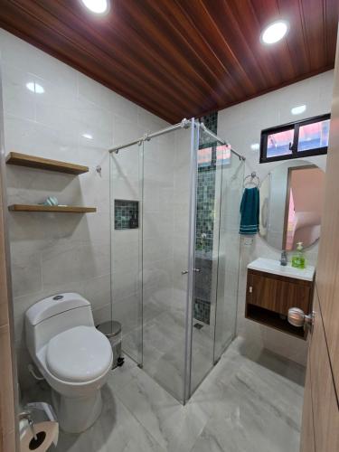 a bathroom with a shower and a toilet and a sink at Finca La Tranquilidad in San Francisco