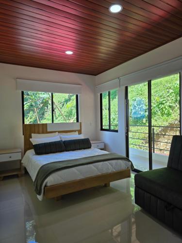 a bedroom with a large bed with a wooden ceiling at Finca La Tranquilidad in San Francisco