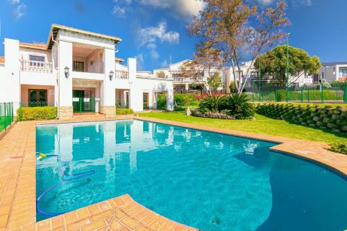 a swimming pool in front of a house at 3 bed Cluster home in Sandton in Sandton