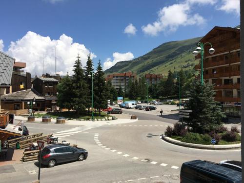 a car driving down a street in a city at Le grenier des rêves in Les Deux Alpes