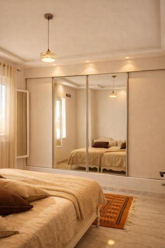 a bedroom with a large mirror on the wall at Dar Al Yaqout in Le Kram