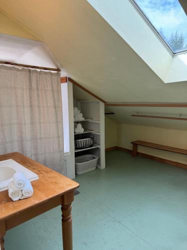 a room with a table and a skylight at Kinsol Hideaway in Shawnigan Lake