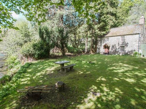 a picnic table in a yard in front of a building at Gardener's Bothy in Balnaboth