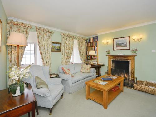 a living room with a couch and a fireplace at Point Park in Taynuilt