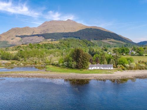 an island in the water with a mountain in the background at Point Park in Taynuilt