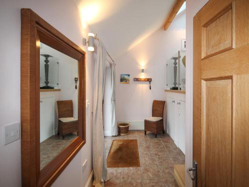 a hallway with two chairs and a mirror at Achabeg - S4597 in Taynish