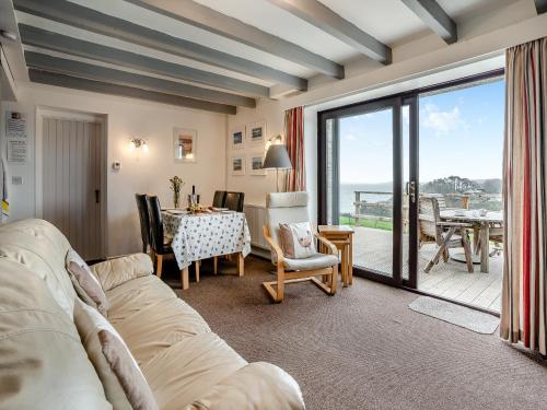 a living room with a couch and a table at Granary Cottage - Uk10695 in Amroth