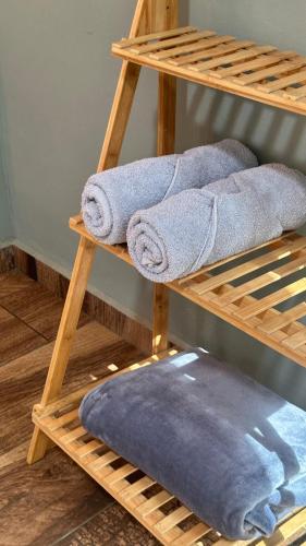 a pile of towels on a wooden shelf at La Villa de los Alas - Boutique in Juayúa