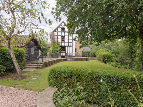 a large house with a garden in front of it at Brook House in Mathon