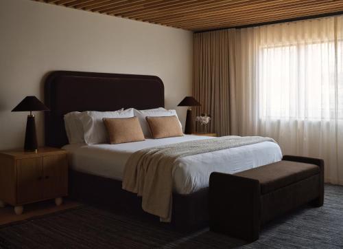 a bedroom with a large bed and a window at The Ivory in Los Angeles