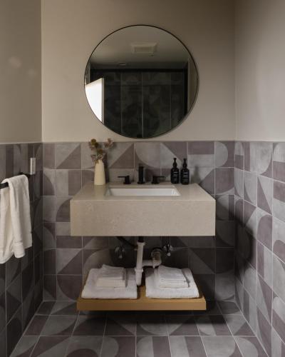 a bathroom with a sink and a mirror at The Ivory in Los Angeles