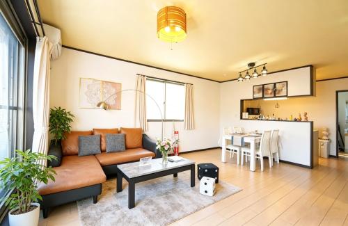 a living room with a couch and a table at Maple Hotel Osaka in Osaka