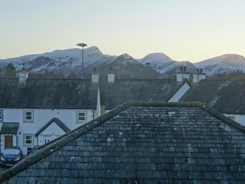 a group of roofs with mountains in the background at 10 Elm Court in Keswick