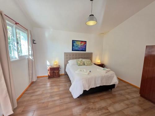 a bedroom with a large bed and two lamps on the floor at La Margarita Aparts - Solo 2 Pax in Mina Clavero