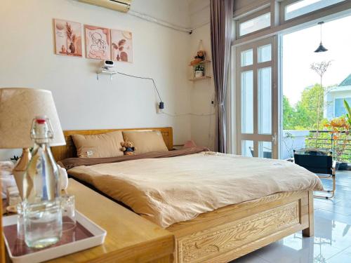 a bedroom with a bed with a table and a window at Chu homestay in Thôn Trường Giang