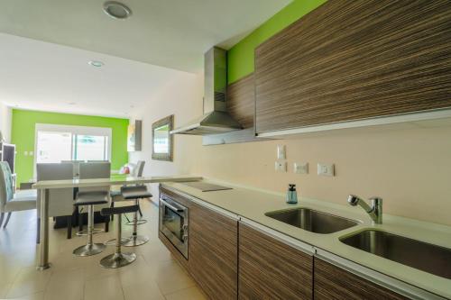 a kitchen with a sink and a counter at Pacifika in Mazatlán