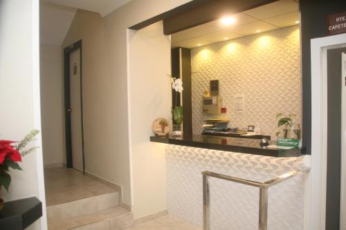 a bathroom with a counter and a mirror at Hostal El Altet in El Altet