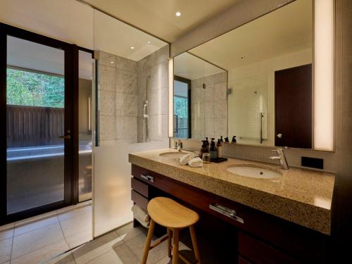 a bathroom with a sink and a large mirror at Hakone Suishoen in Hakone
