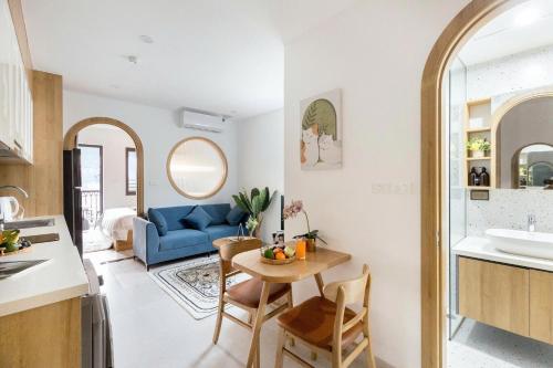 a kitchen and living room with a blue couch at Artsy Boutique Studio in Hanoi