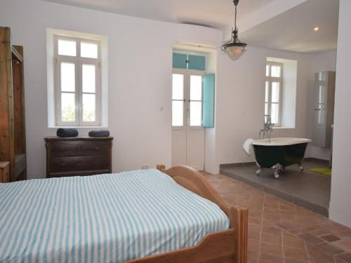 a bedroom with a bed and a bath tub at Delightful, authentic Quinta with pool in Loulé