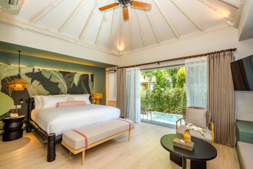 a bedroom with a bed and a large window at Davinia Hua Hin Resort in Hua Hin