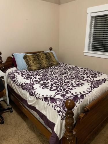 a bedroom with a bed with a black and white comforter at Waterfront home in Gig Harbor