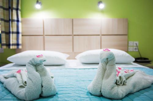 two stuffed animals are laying on a bed at Angeliki Beach Hotel in Megali Ammos