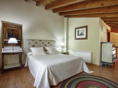 a bedroom with a large white bed and a window at Mansion in Nava with Pool & Terrace in Nava