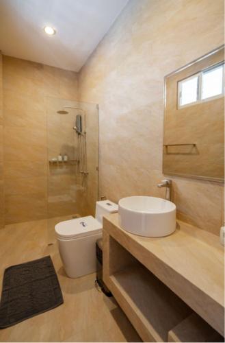 a bathroom with a sink and a toilet and a shower at La Cha Cha Residence in Ban Thalat Choeng Thale