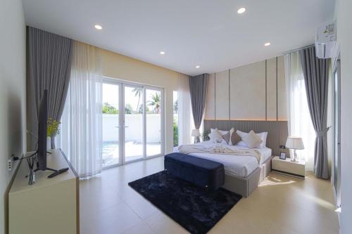 a bedroom with a bed and a television in it at 3BR Luxury Pool Villa, Hua Hin (TP3) in Hua Hin