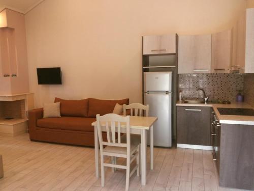 a kitchen and living room with a couch and a table at Giannis Village Resort in Astakós